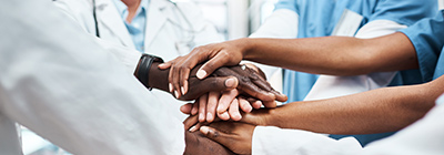 Hands joining over a world map